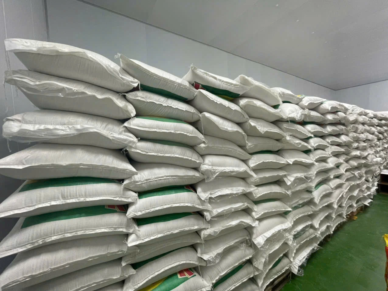 Stacked rice bags in the supplied storage-area photograph